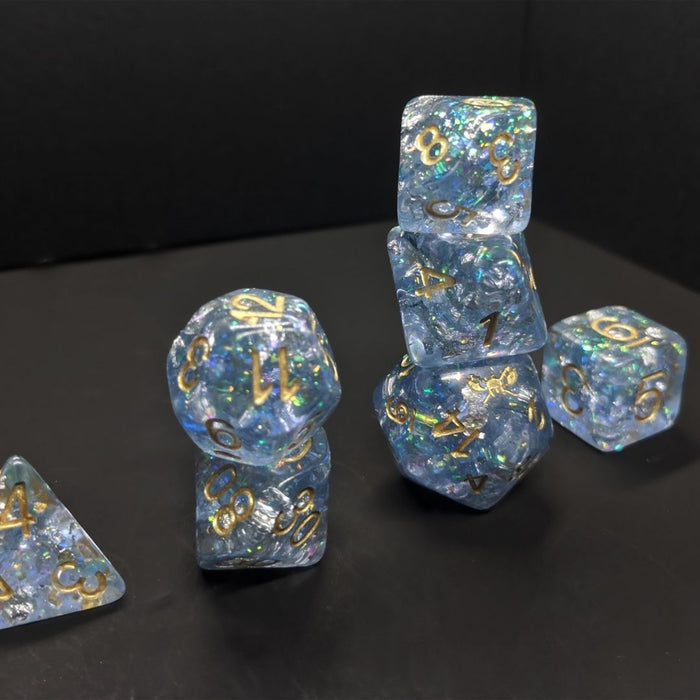 Snowmaiden's Kiss™️ - Light Blue with Foil Inclusions and Gold Numbers Dice Set